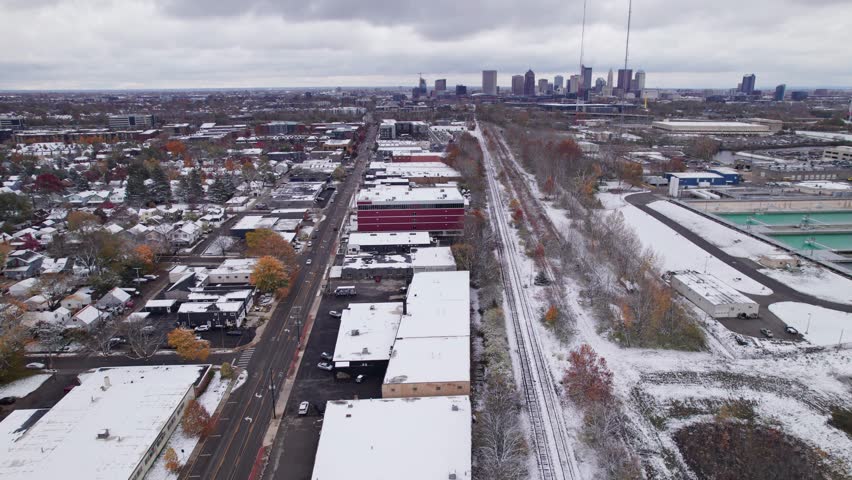 Wintry landscape with snow, cold, and ice from drone aerial above central Ohio midwestern city of Columbus, OH in North America in early winter as white frost sits on building roofs in neighborhood