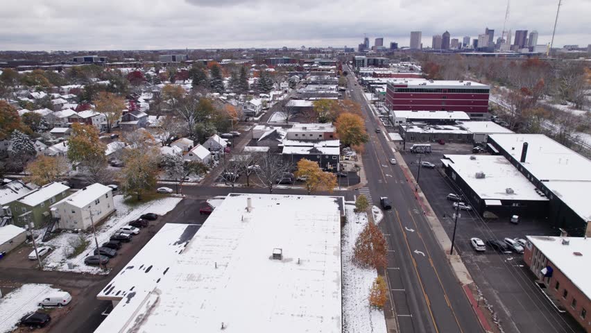 Wintry landscape with snow, cold, and ice from drone aerial above central Ohio midwestern city of Columbus, OH in North America in early winter as white frost sits on building roofs in neighborhood