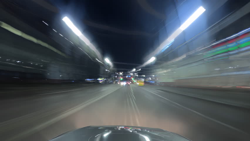 Dynamic night city time-lapse filmed from a moving car, showing bright light trails from traffic and streetlights. Perfect for urban, travel, or nightlife themed video projects. - Powered by Shutterstock - Get 15% off with code: PIKWIZARD15