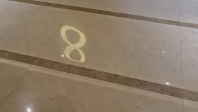 Floating golden letter 8 rests on a tiled floor, combining shine of gold with patterned reflections. - Powered by Shutterstock - Get 15% off with code: PIKWIZARD15