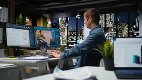 Portrait of male specialist in office uses CAD software and blueprints plan, designing house interior with user interface for virtual home customization. Detailed architectural layout. Camera A. - Powered by Shutterstock - Get 15% off with code: PIKWIZARD15