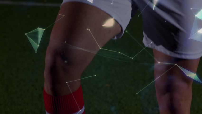 Male athlete in red kit standing by goal net, camera rising revealing hologram globe sports promo. Holographic, polygonal, digital, futuristic, dynamic, studio, stadium