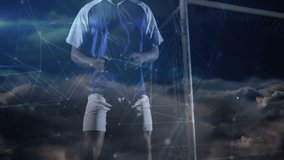 Male soccer player bracing, jumping as opponent entering, contesting goal under night network lines. Athletic, football, dark, digital, aerial, net, stadium - Powered by Shutterstock - Get 15% off with code: PIKWIZARD15