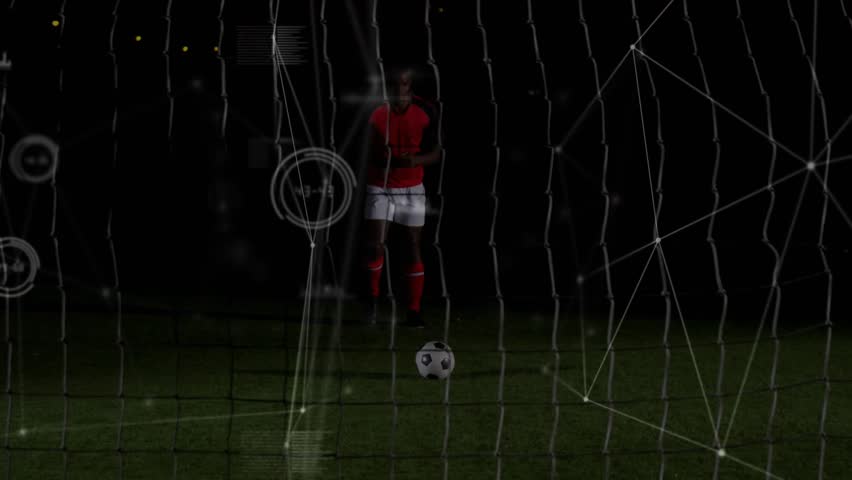 Male soccer player stepping forward, kicking ball through goal net while tech HUD analyzing shot. Pitch, night, outdoor, football, athlete, uniform, overlay - Powered by Shutterstock - Get 15% off with code: PIKWIZARD15