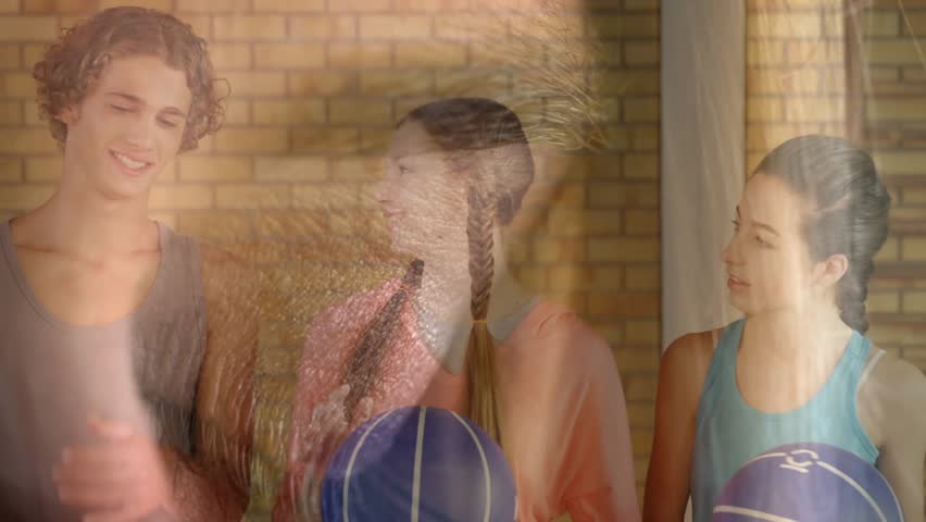 Teens holding balls, glancing, head-turning causing eyecode overlay moving across faces for sports. Youth, basketball, teamwork, friendship, urban, brick, window