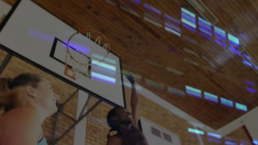 Male releasing ball at hoop, female jumping to score in sports, purple blue glitch bars overlaying. Basketball, gymnasium, leap, drill, defense, rebound, observer