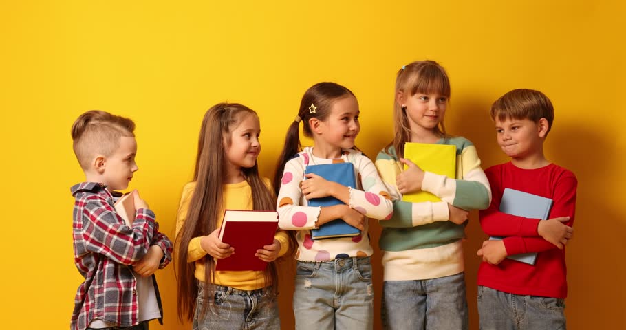 Cute kids with books on orange background