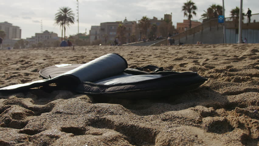 Surfer man walking to the beach at sunset preparing for surfing training and search for waves in Barcelona, spain, water, ocean exercise in sea with board, athletic male holiday or travel in vacation.