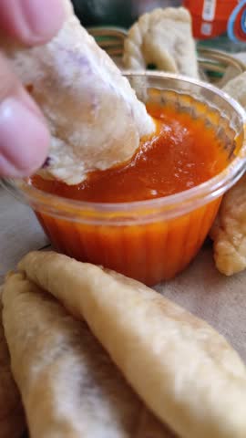 Crispy cireng served warm with spicy savory sauce, showcasing its chewy texture and irresistible street-food appeal.