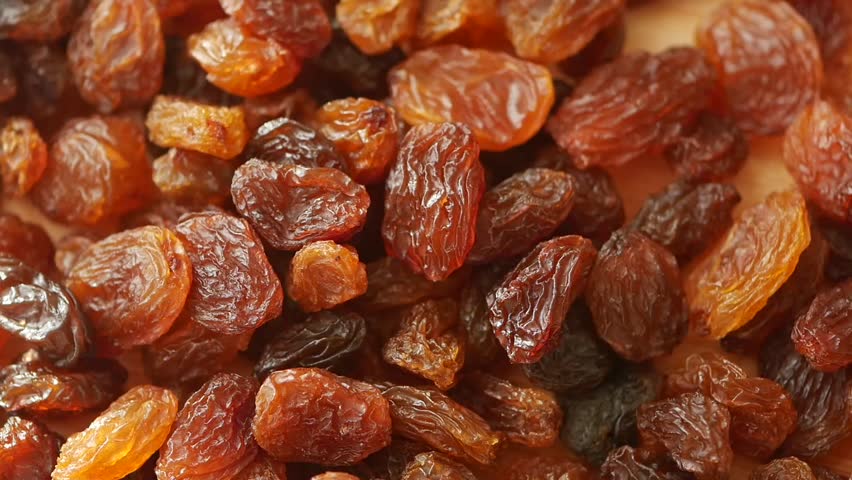 slow motion of Raisins drops on a plate 