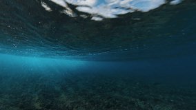 Underwater view of the ocean wave breaking on the shore during sunset light in the Maldives - Powered by Shutterstock - Get 15% off with code: PIKWIZARD15