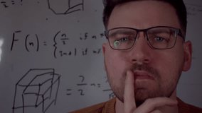 Tight shot of a man wearing futuristic holographic smart glasses, focused on solving a scientific equation. Glowing formulas appear in the background, symbolising AI, innovation, and advanced tech - Powered by Shutterstock - Get 15% off with code: PIKWIZARD15