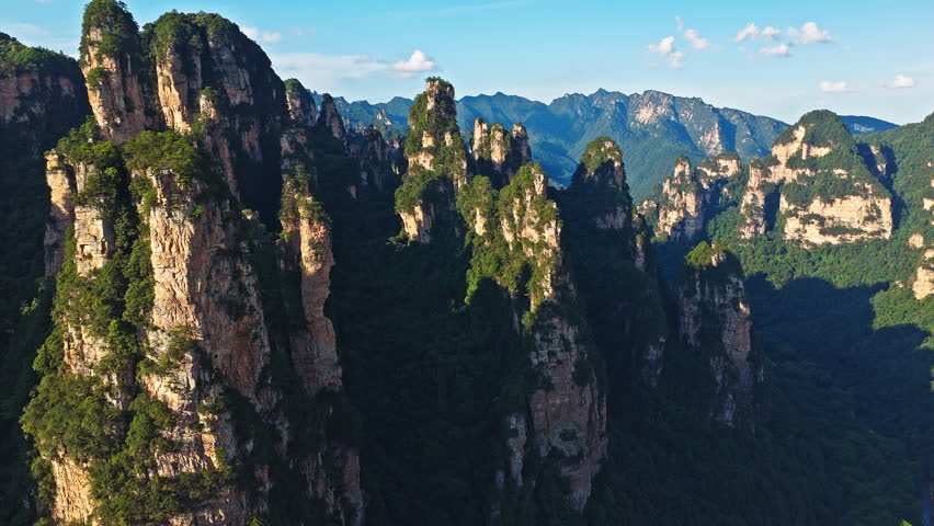 Majestic Zhangjiajie national forest park, towering sandstone pillars covered in lush green forest in Hunan, China.
