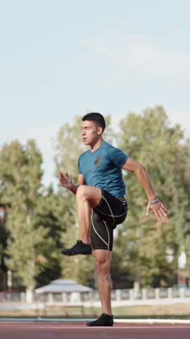 runner man standing on stadium after workout vertical slow motion fullHD calm focus discipline reflection strength inner peace morning light motivation balance confidence
