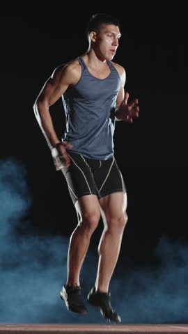 athlete man focused on goal vertical slow motion fullhd moment of inner strength power confidence motivation self control balance health body awareness discipline mindset