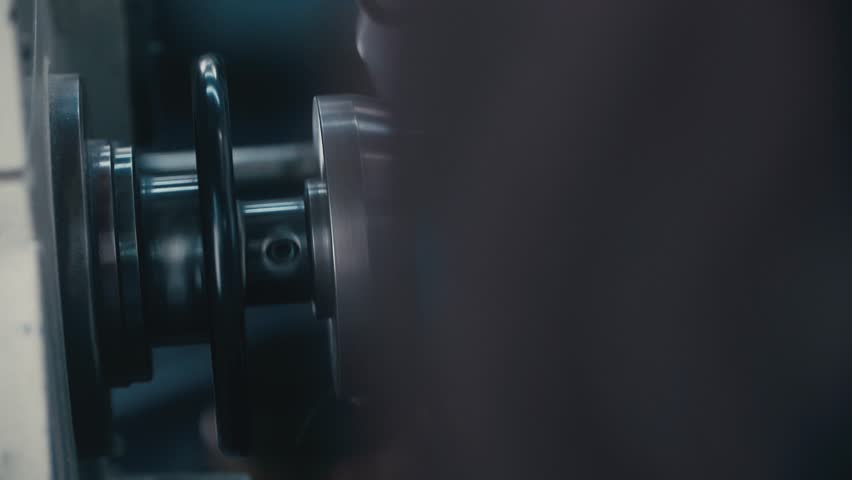 Reveal shot of Machine winding copper coil in slow motion, showcasing detail, craftsmanship, and modern manufacturing technology.