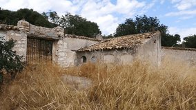Panoramic view of the abandoned cemetery in the village of Otiñar, Jaén. It shows ruined tombs and stone walls. - Powered by Shutterstock - Get 15% off with code: PIKWIZARD15