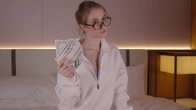 Young rich woman boss waving money dollar cash banknotes bills like a fan, happy businesswoman entrepreneur showing success business career, lottery winner big income wealth profit salary bonus - Powered by Shutterstock - Get 15% off with code: PIKWIZARD15