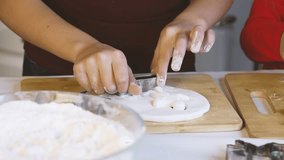 Little girl is using a cookie cutter to make Christmas-themed cookies - Powered by Shutterstock - Get 15% off with code: PIKWIZARD15