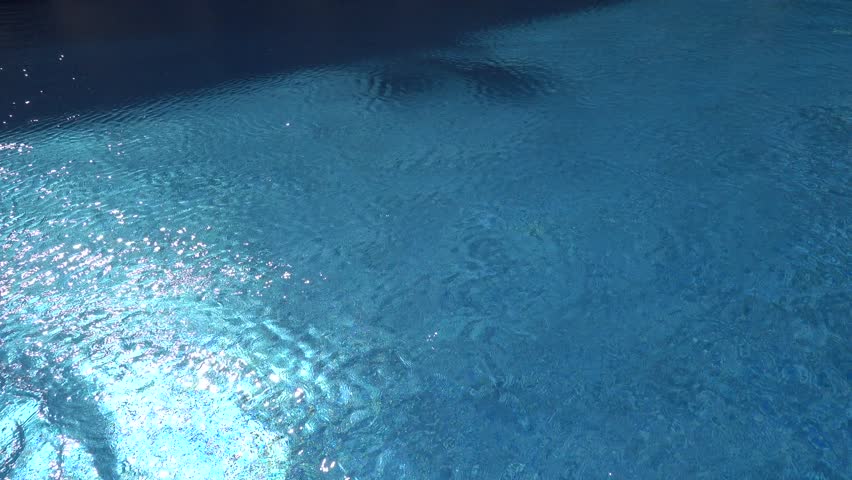 Sousse, Tunisia A man swims breaststroke in a blue outdoor pool. 