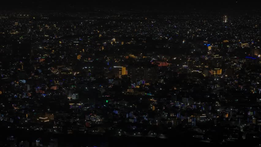 Aerial night footage of Kathmandu city during Diwali (Tihar), featuring the illuminated Dharahara Tower and glowing skyline filled with festive lights, showing Nepal’s vibrant cultural celebration.