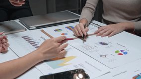 Group of business professionals discussing and analyzing financial data and marketing reports at a meeting - Powered by Shutterstock - Get 15% off with code: PIKWIZARD15