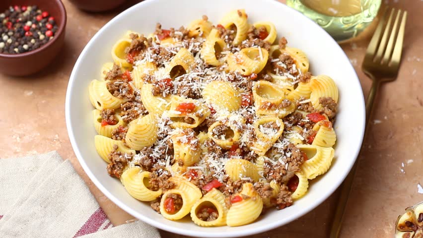 Pasta with bolognese sauce and cheese. Italian cuisine. Traditional recipe.