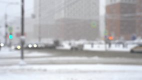 Blurred street of big city and crossroad with moving cars in snowfall in winter. Urban winter cityscape with snowstorm in defocus. Weather concept - Powered by Shutterstock - Get 15% off with code: PIKWIZARD15