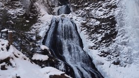Waterfall in the mountains during extreme cold winter with icicles. Rachitele, Romania - Powered by Shutterstock - Get 15% off with code: PIKWIZARD15