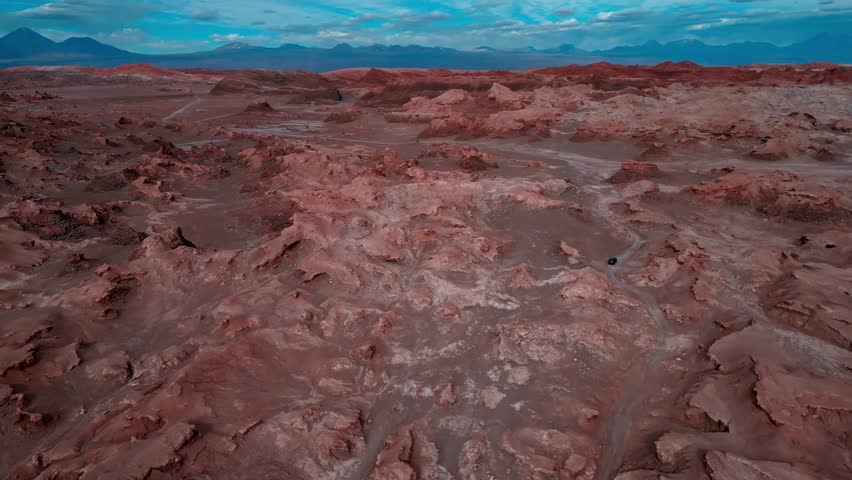 Description:
Forward drone aerial of Valle de la Luna's Mars-like landscape, San Pedro de Atacama, Chile with red rock formations and dramatic desert terrain