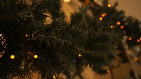 Christmas garland with twinkling lights decorates the greenery, creating a festive Christmas atmosphere. The lights on the garland enhance the holiday spirit in the room. - Powered by Shutterstock - Get 15% off with code: PIKWIZARD15