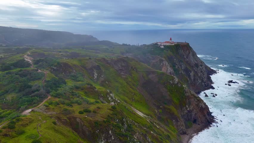 An Aerial view of Cabo da Roca cliffs in Portugal, where rugged rocks meet the Atlantic Ocean waves