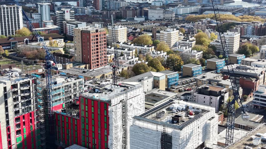 A construction site dominated by cranes , emphasizing growth and the evolution of the urban landscape in modern cities in London UK