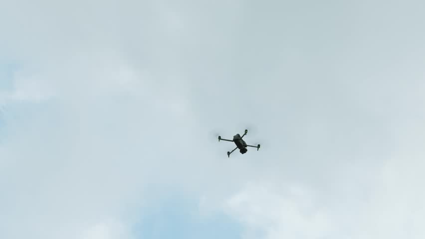 DJI Matrice 4T, drone flying in cloudy sky. Low-angle pov, copy space