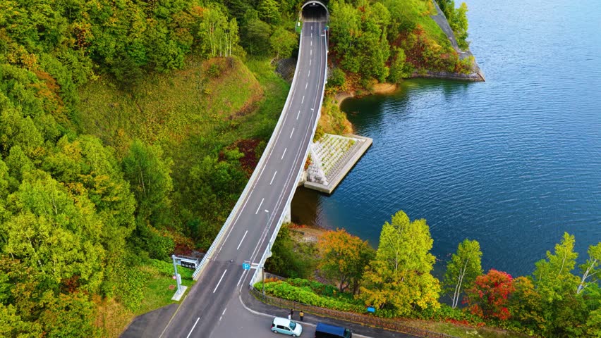 Aerial view of Sapporo Dam Road to Jozankei, Tourist Bus Crossing Bridge 4k