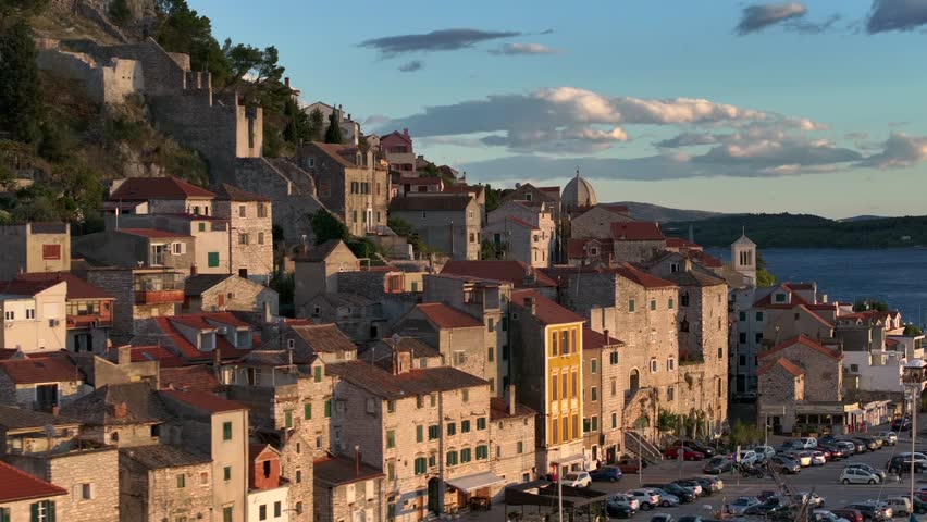 Amazing Flyby at Sunset over Sibenik, Croatia. St. James Cathedral, a UNESCO World Heritage, terracotta rooftops.