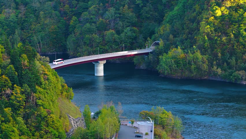 Autumn in Japan, Bus Crossing Bridge over Jozankei Dam in Mountains of Sapporo
