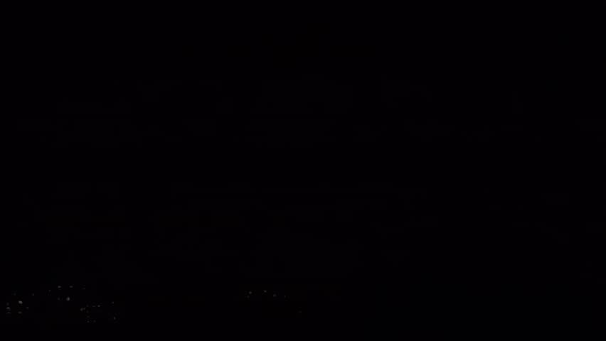 Dramatic Nighttime Lightning Strike Over Silhouette of Trees Capturing Nature