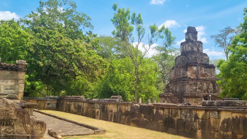 Satmahal Prasada, a rare 12th-century stepped pyramid in ancient Polonnaruwa, Sri Lanka, basks under the bright sun, showcasing its unique architectural charm