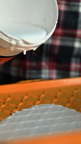 Pouring White Paint From Paint Can For Walls Into Tray