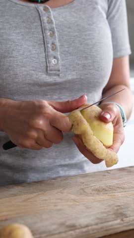 Girl Peeling Raw Potatoes And Vegetables With A Knife, Vertical Video