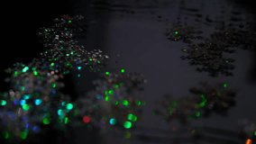 Shiny holographic snowflakes confetti on wet mirror dark background. Winter atmospheric mood. Holiday spirit. Merry Christmas and Happy New Year	 - Powered by Shutterstock - Get 15% off with code: PIKWIZARD15