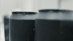 Sleek matte black aluminum cans sporting water droplets and condensation, showcasing refreshing beverage packaging against pristine white background - Powered by Shutterstock - Get 15% off with code: PIKWIZARD15