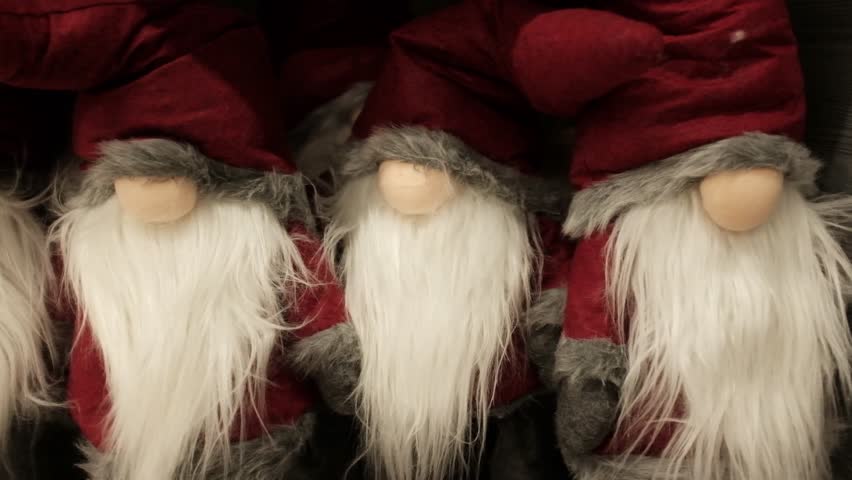 Santa Claus soft cosy cute traditional Christmas plush toys. Winter holidays decoration and toys for kids. Xmas spirit gifts, holidays items, store shelves merchandise. Getting ready for Christmas.