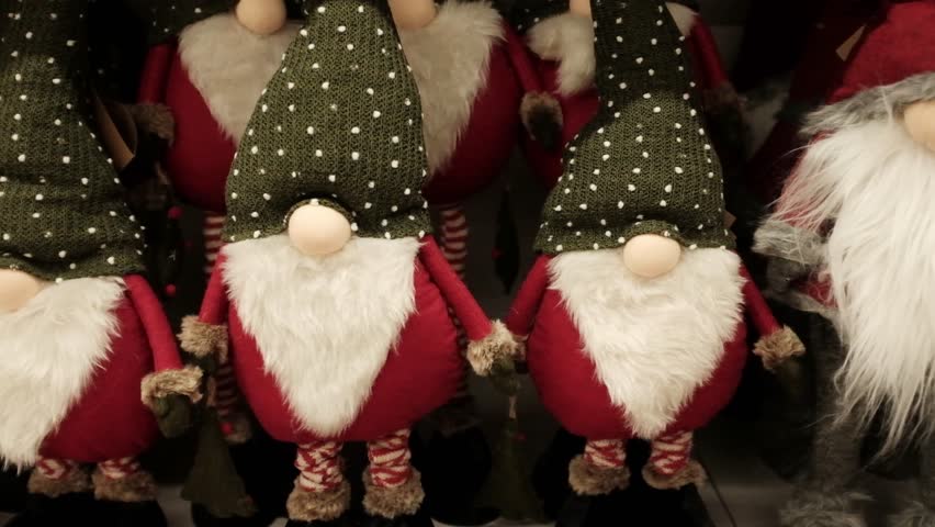 Santa Claus soft cozy cute traditional Christmas plush toys. Winter holidays decoration and toys for kids. Xmas spirit gifts, holidays items, store shelves merchandise. Getting ready for Christmas.