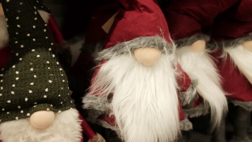 Santa Claus soft cozy cute traditional Christmas plush toys. Winter holidays decoration and toys for kids. Xmas spirit gifts, holidays items, store shelves merchandise. Getting ready for Christmas.