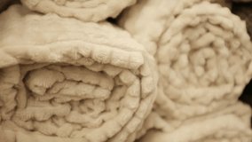 Rolled fluffy cozy and soft plush blankets. Modern aesthetic comfortable living room or bedroom home decor. Snuggly bedding covers. Store shelves merchandise display. - Powered by Shutterstock - Get 15% off with code: PIKWIZARD15