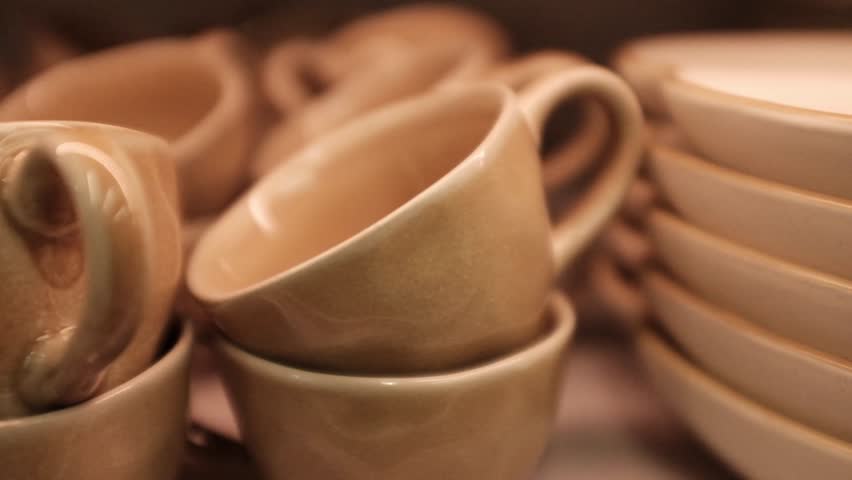 Stack of small minimalist aesthetic ceramic cups for coffee. Cafe, restaurant utensils. Stylish dusty pink coffee cups. Cute home decor, kitchen and dining room dishware. Home decor store merchandise.