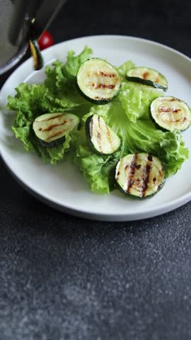 Zucchini grilled salad tomato, lettuce tasty snack fresh delicious gourmet food background on the table rustic food top view copy space keto and paleo diet vegan and vegetarian food