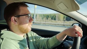 A man in a car. A man wearing glasses. Slow motion. High-quality 4K footage. - Powered by Shutterstock - Get 15% off with code: PIKWIZARD15